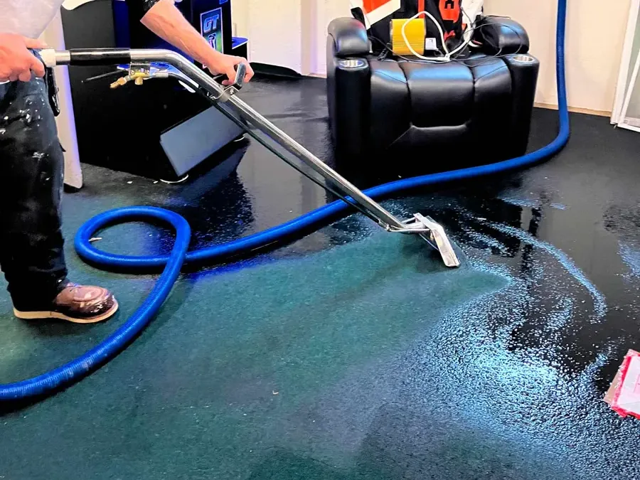 Extraction wand removing water from soaked indoor carpet